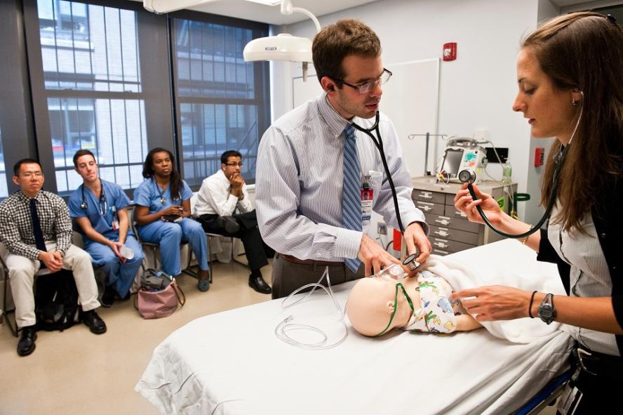 Male and female students working together on a Pediatric Emergency Medicine exercise in the Clinical Skills and Simulation Center.